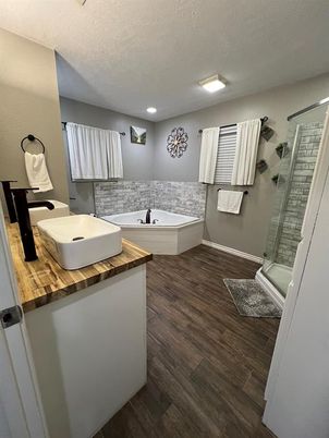 Bathroom, Dual Sink Vanities, Glass Shower, Interior, Recessed Lighting, Wood Texture Flooring