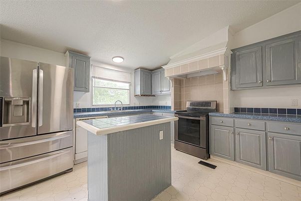 Interior, Kitchen, Recessed Lighting, Stainless Steel Appliances, Tile Countertops