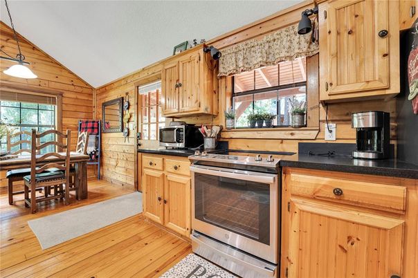 Dining room, Interior, Kitchen, Pendant Lights, Stainless Steel Appliances, Wood Texture Flooring, Wooden Walls