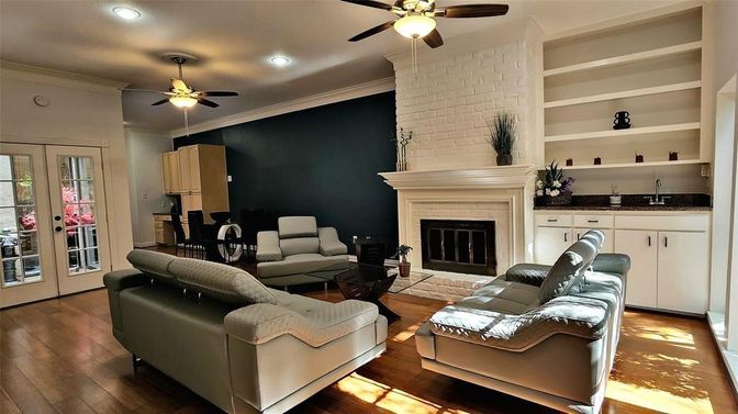 Dining room, Fireplace, Interior, Living room, Recessed Lighting, Stone Walls, Wood Texture Flooring