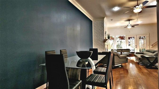 Dining room, Fireplace, Interior, Living room, Recessed Lighting, Stone Walls, Wood Texture Flooring