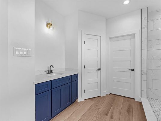 Bathroom, Dual Sink Vanities, Interior, Marble Walls, Recessed Lighting, Wood Texture Flooring