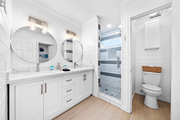 Bathroom, Dual Sink Vanities, Glass Shower, Interior, Recessed Lighting, Wood Texture Flooring