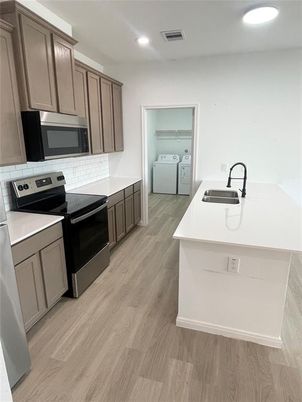 Interior, Kitchen, Recessed Lighting, Washer, Wood Texture Flooring