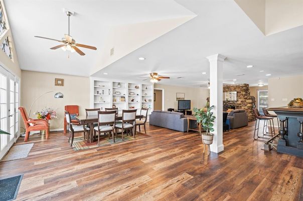 Dining room, Fireplace, Interior, Living room, Recessed Lighting, Stone Walls, Wood Texture Flooring
