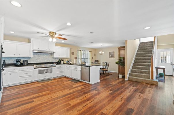 Chandelier, Dining room, Interior, Kitchen, Recessed Lighting, Stainless Steel Appliances, Wood Texture Flooring