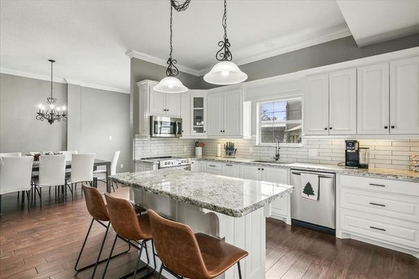 Chandelier, Dining room, Interior, Kitchen, Pendant Lights, Stainless Steel Appliances, Wood Texture Flooring
