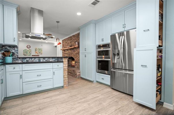 Fireplace, Interior, Kitchen, Pendant Lights, Recessed Lighting, Stainless Steel Appliances, Stone Walls, Wood Texture Flooring