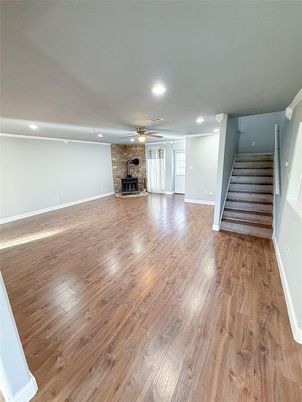 Empty room, Fireplace, Interior, Recessed Lighting, Stone Walls, Wood Texture Flooring