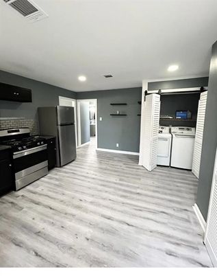 Interior, Kitchen, Recessed Lighting, Washer, Wood Texture Flooring