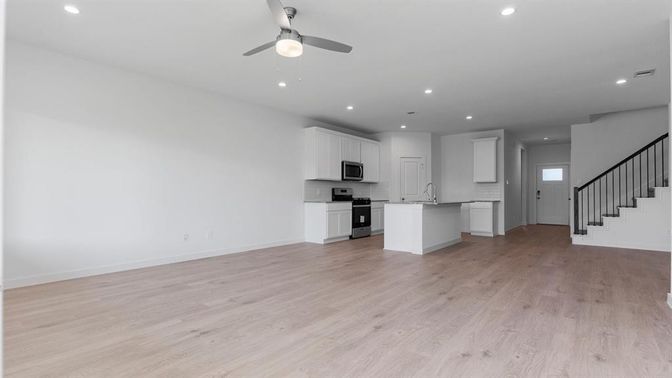 Empty room, Interior, Kitchen, Recessed Lighting, Stainless Steel Appliances, Wood Texture Flooring