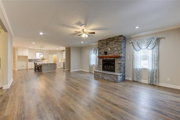 Empty room, Fireplace, Interior, Kitchen, Pendant Lights, Recessed Lighting, Stone Walls, Wood Texture Flooring