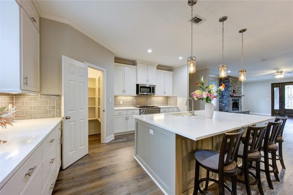 Fireplace, Interior, Kitchen, Pendant Lights, Recessed Lighting, Stainless Steel Appliances, Wood Texture Flooring