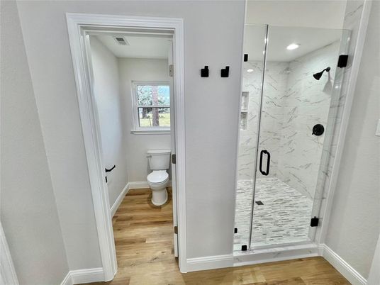 Bathroom, Glass Shower, Interior, Marble Walls, Recessed Lighting, Wood Texture Flooring