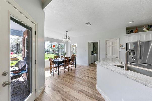 Chandelier, Dining room, Interior, Kitchen, Pendant Lights, Recessed Lighting, Stainless Steel Appliances, Wood Texture Flooring