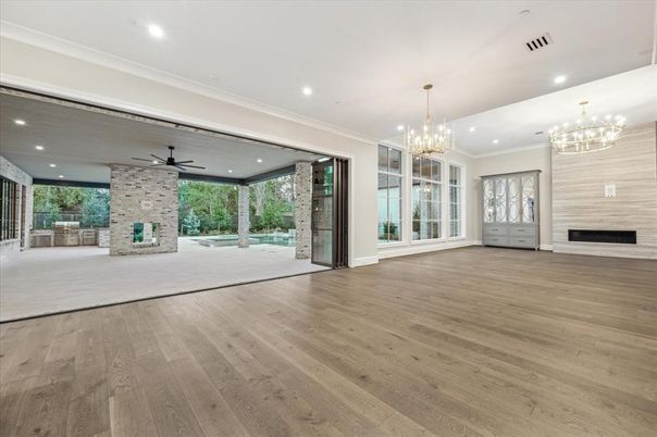 Chandelier, Empty room, Fireplace, Interior, Recessed Lighting, Stone Walls, Wood Texture Flooring