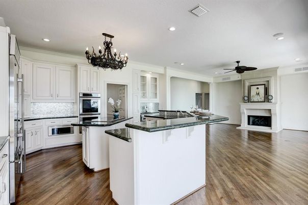 Chandelier, Fireplace, Interior, Kitchen, Recessed Lighting, Stainless Steel Appliances, Wood Texture Flooring