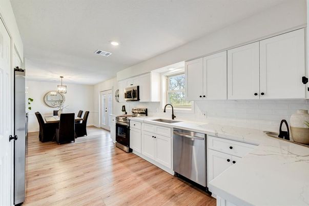 Chandelier, Dining room, Interior, Kitchen, Recessed Lighting, Stainless Steel Appliances, Wood Texture Flooring