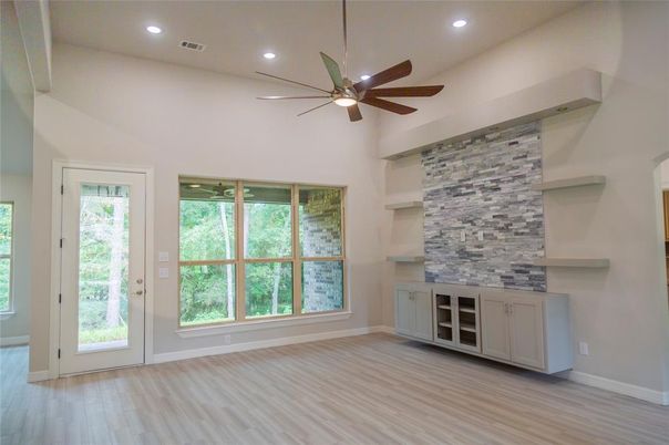 Empty room, Fireplace, Interior, Recessed Lighting, Stone Walls, Wood Texture Flooring