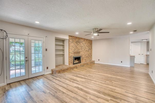 Empty room, Fireplace, Interior, Recessed Lighting, Stone Walls, Wood Texture Flooring
