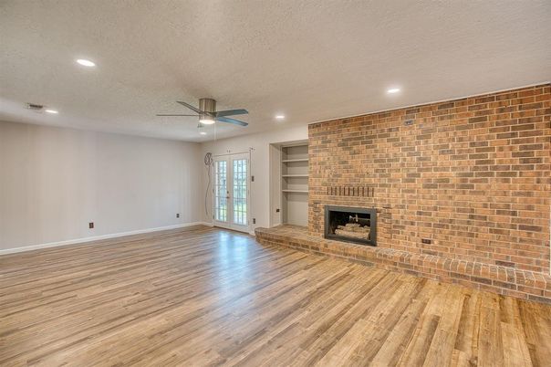Empty room, Fireplace, Interior, Recessed Lighting, Stone Walls, Wood Texture Flooring