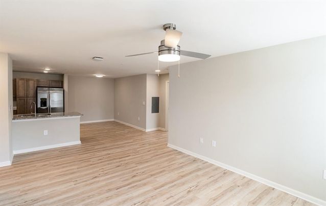 Empty room, Interior, Kitchen, Recessed Lighting, Stainless Steel Appliances, Wood Texture Flooring