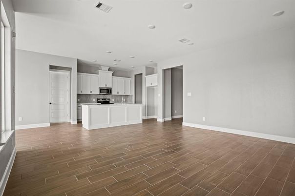 Empty room, Interior, Kitchen, Recessed Lighting, Stainless Steel Appliances, Wood Texture Flooring