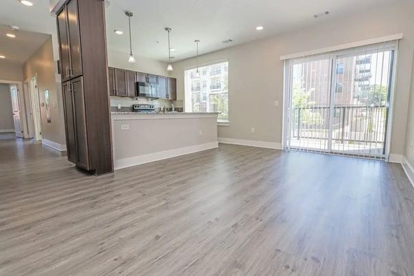 Empty room, Interior, Kitchen, Pendant Lights, Recessed Lighting, Stainless Steel Appliances, Wood Texture Flooring