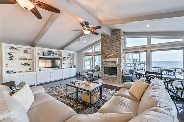 Dining room, Fireplace, Interior, Living room, Recessed Lighting, Stone Walls, Water, Wooden Beams, Wood Texture Flooring