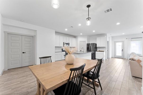 Dining room, Interior, Kitchen, Pendant Lights, Recessed Lighting, Stainless Steel Appliances, Wood Texture Flooring