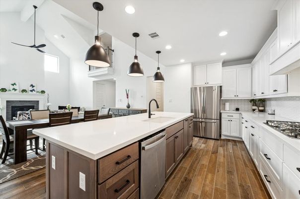 Dining room, Fireplace, Interior, Kitchen, Pendant Lights, Recessed Lighting, Stainless Steel Appliances, Wood Texture Flooring
