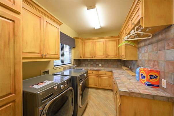 Interior, Kitchen, Tile Countertops, Washer, Wood Texture Flooring