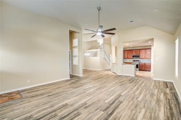 Empty room, Interior, Kitchen, Recessed Lighting, Stainless Steel Appliances, Wood Texture Flooring