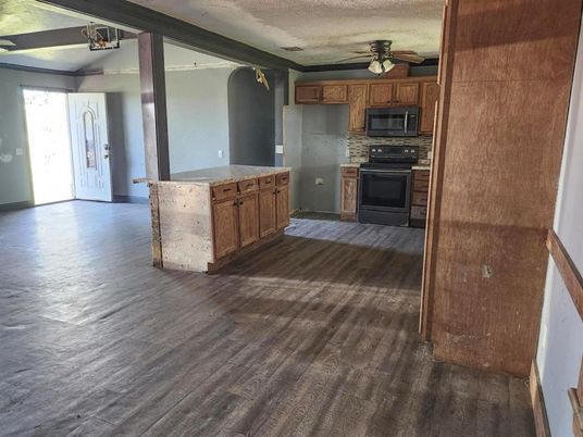 Empty room, Fireplace, Interior, Kitchen, Stainless Steel Appliances, Wood Texture Flooring