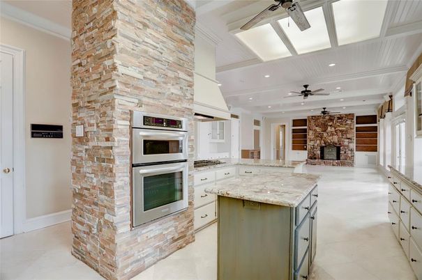 Fireplace, Interior, Kitchen, Recessed Lighting, Stainless Steel Appliances, Stone Walls
