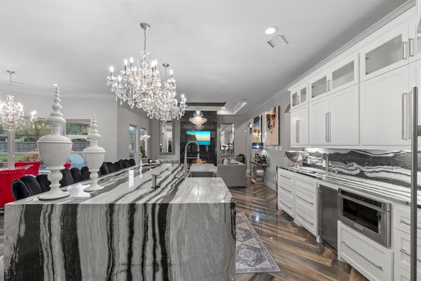 Chandelier, Fireplace, Interior, Kitchen, Living room, Recessed Lighting, Wood Texture Flooring
