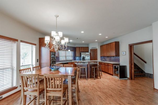 Chandelier, Dining room, Interior, Kitchen, Recessed Lighting, Stainless Steel Appliances, Wood Texture Flooring