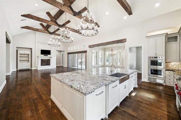 Chandelier, Fireplace, Interior, Kitchen, Pendant Lights, Recessed Lighting, Stainless Steel Appliances, Wooden Beams, Wood Texture Flooring