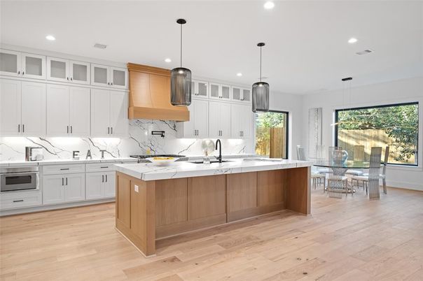 Dining room, Interior, Kitchen, Marble Walls, Pendant Lights, Recessed Lighting, Stainless Steel Appliances, Wood Texture Flooring