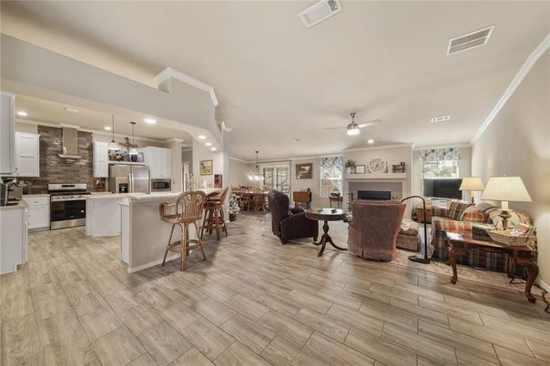Dining room, Fireplace, Interior, Kitchen, Living room, Pendant Lights, Recessed Lighting, Stainless Steel Appliances, Wood Texture Flooring