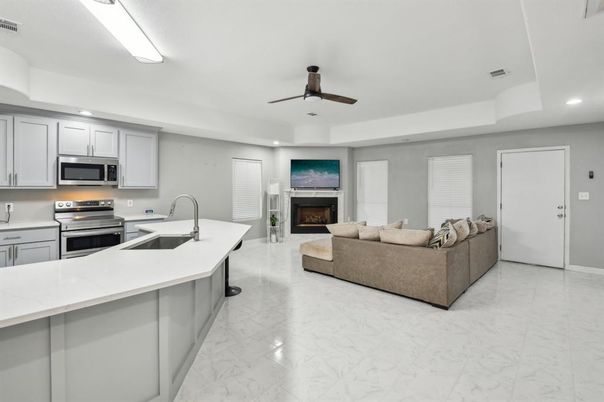 Fireplace, Interior, Kitchen, Living room, Marble, Recessed Lighting, Stainless Steel Appliances