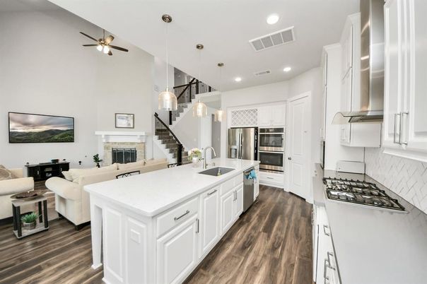 Fireplace, Interior, Kitchen, Living room, Pendant Lights, Recessed Lighting, Stainless Steel Appliances, Wood Texture Flooring