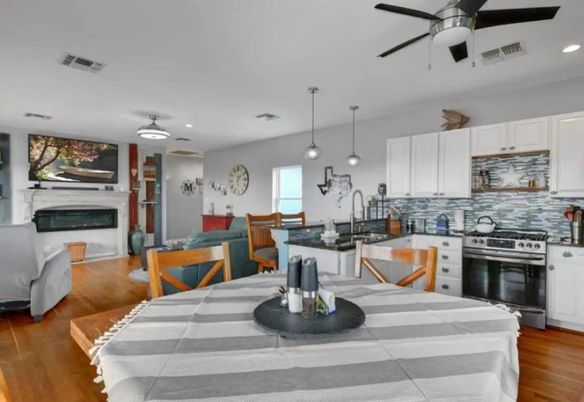 Dining room, Fireplace, Interior, Kitchen, Pendant Lights, Recessed Lighting, Stainless Steel Appliances, Wood Texture Flooring
