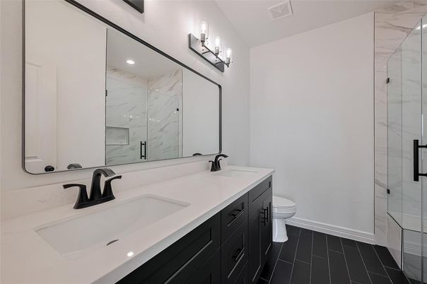 Bathroom, Dual Sink Vanities, Glass Shower, Interior, Marble Walls, Recessed Lighting, Wood Texture Flooring