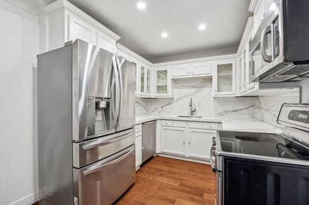 Interior, Kitchen, Marble Walls, Recessed Lighting, Stainless Steel Appliances, Wood Texture Flooring