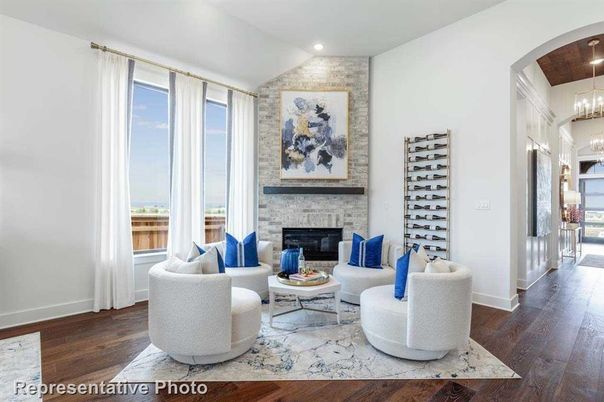 Chandelier, Fireplace, Interior, Living room, Pendant Lights, Recessed Lighting, Stone Walls, Wood Texture Flooring