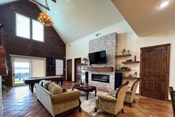 Billiard Table, Chandelier, Fireplace, Game Room, Interior, Living room, Recessed Lighting, Stone Walls, Wood Texture Flooring, Wooden Walls