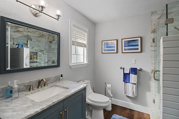 Bathroom, Dual Sink Vanities, Glass Shower, Interior, Marble Walls, Wood Texture Flooring