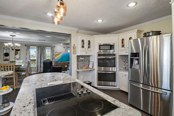 Chandelier, Dining room, Interior, Kitchen, Recessed Lighting, Stainless Steel Appliances, Wood Texture Flooring