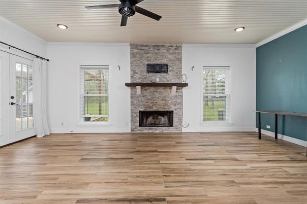 Empty room, Fireplace, Interior, Recessed Lighting, Stone Walls, Wood Texture Flooring